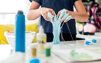 boy mixing the mixture to make Slime