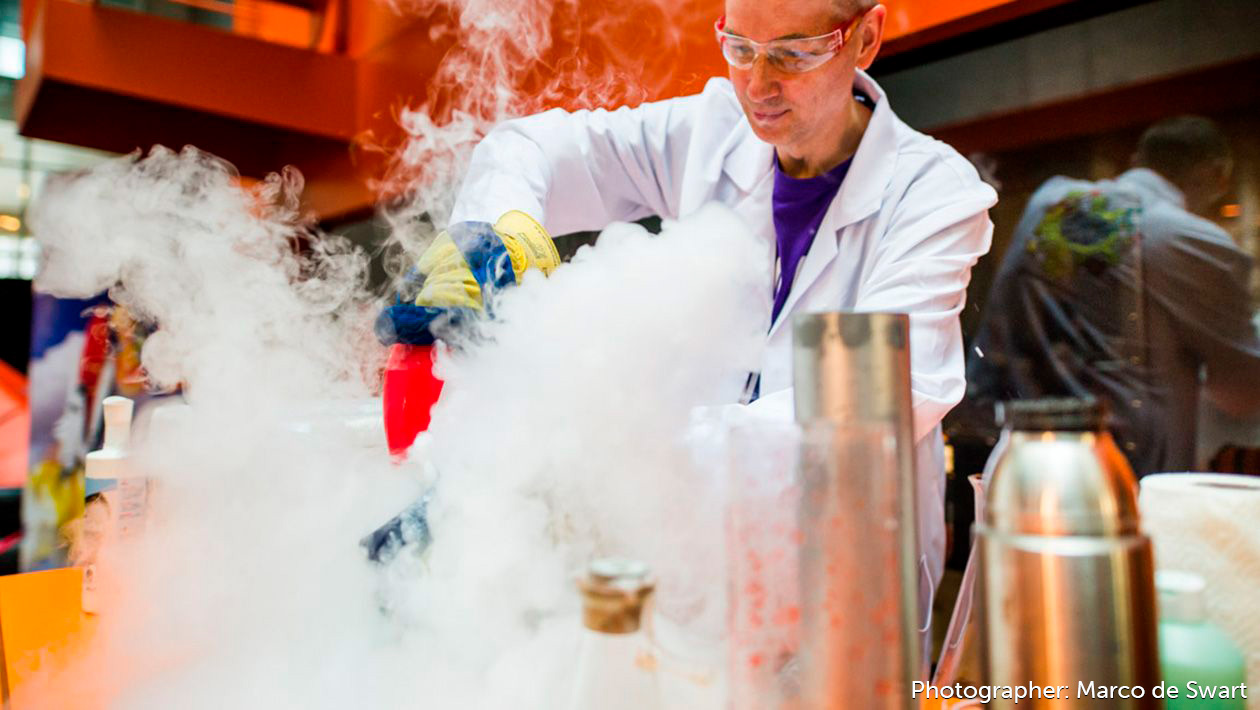 Mad Scientist working in a lab with tons of smoke pouring out of beakers