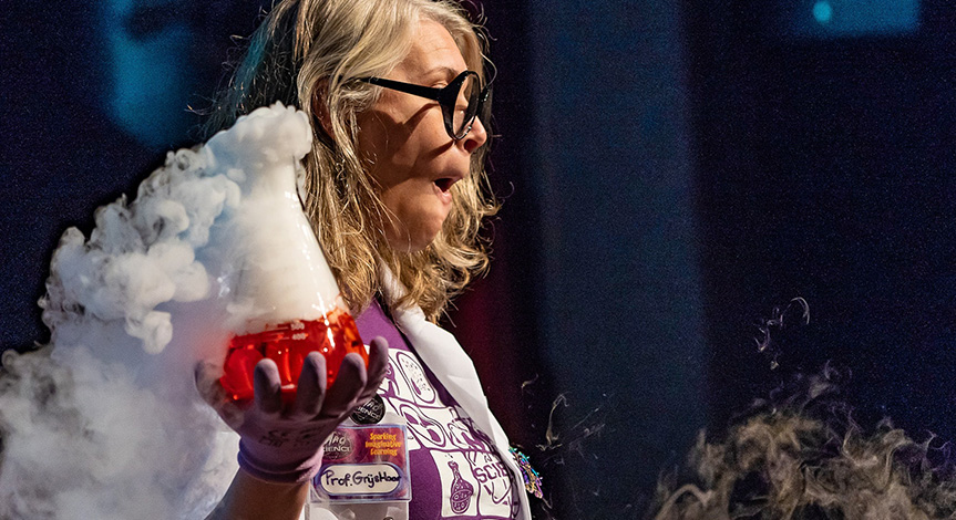 Mad scientist holding a beaker with red liquid in it and smoke pouring out