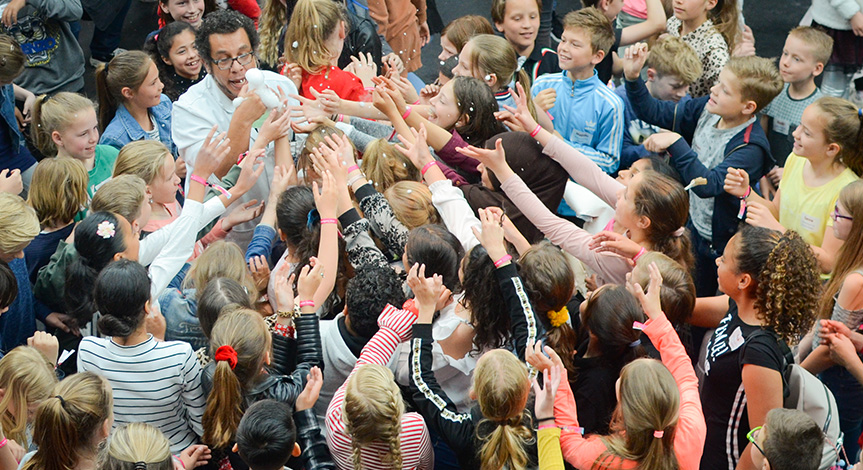 Kids reaching for foam held by a mad scientist